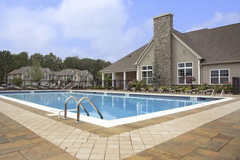 a swimming pool in front of a house