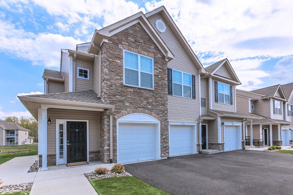 the front of a house with two garage doors