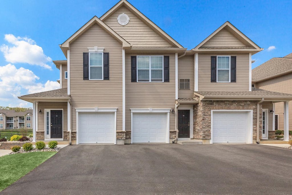 a house with two garage doors and a driveway