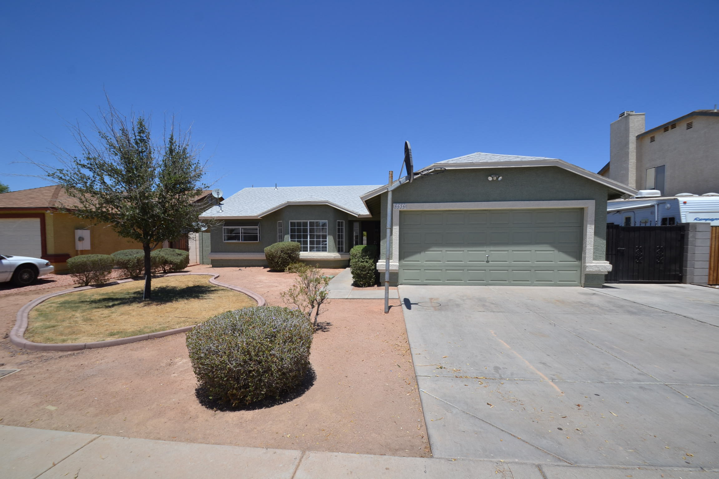 a house with a driveway and a green garage door