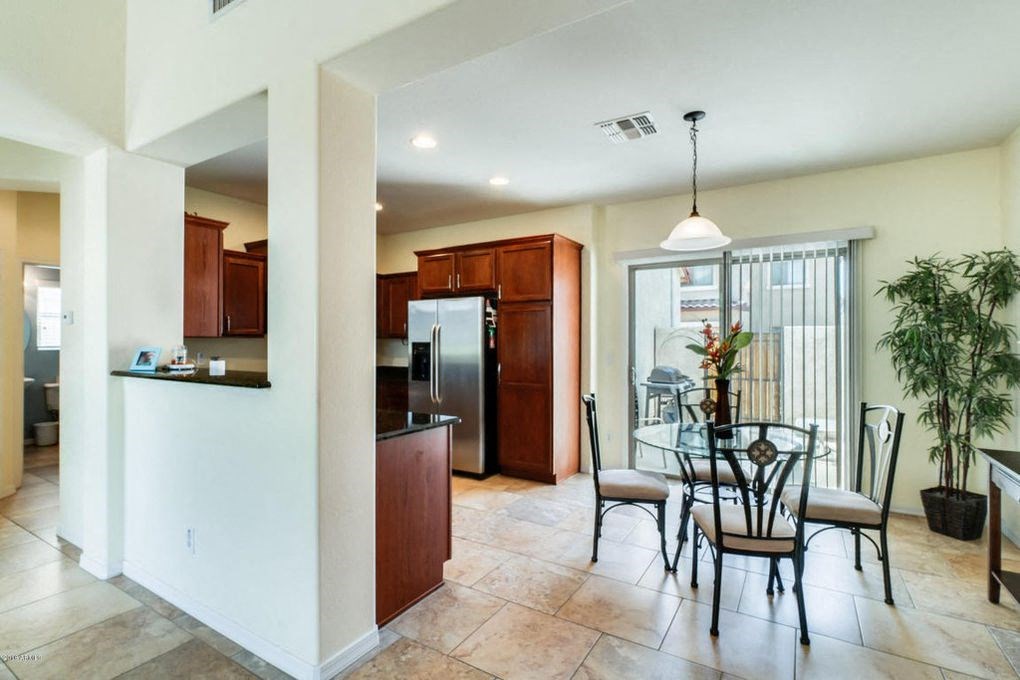 a kitchen and dining room with a table and chairs