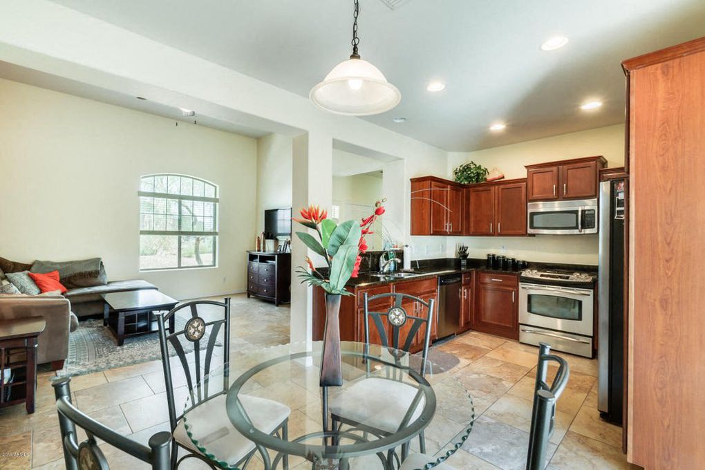 a kitchen and dining room with a glass table and chairs