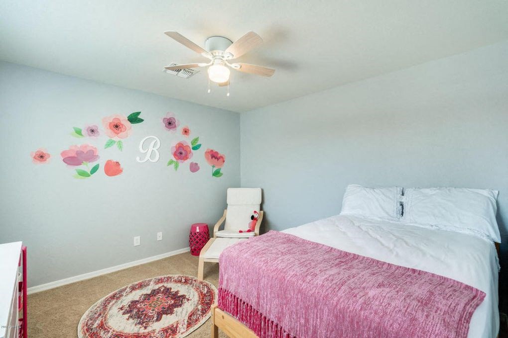 a bedroom with a bed and a ceiling fan