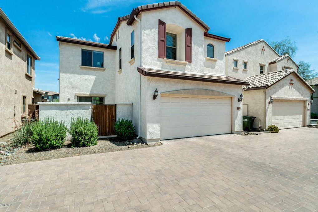 a white house with a garage and a driveway
