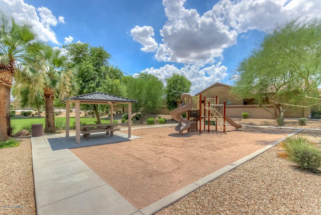 a playground with a slide and a picnic table in a park