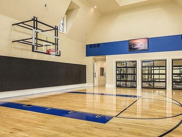 a basketball court in the middle of a large room