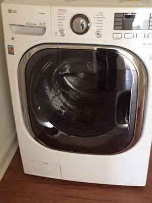 a white washing machine with a glass door
