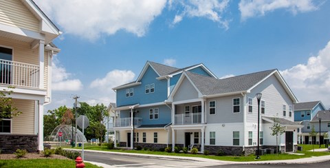 a row of blue and white houses on the corner of a street