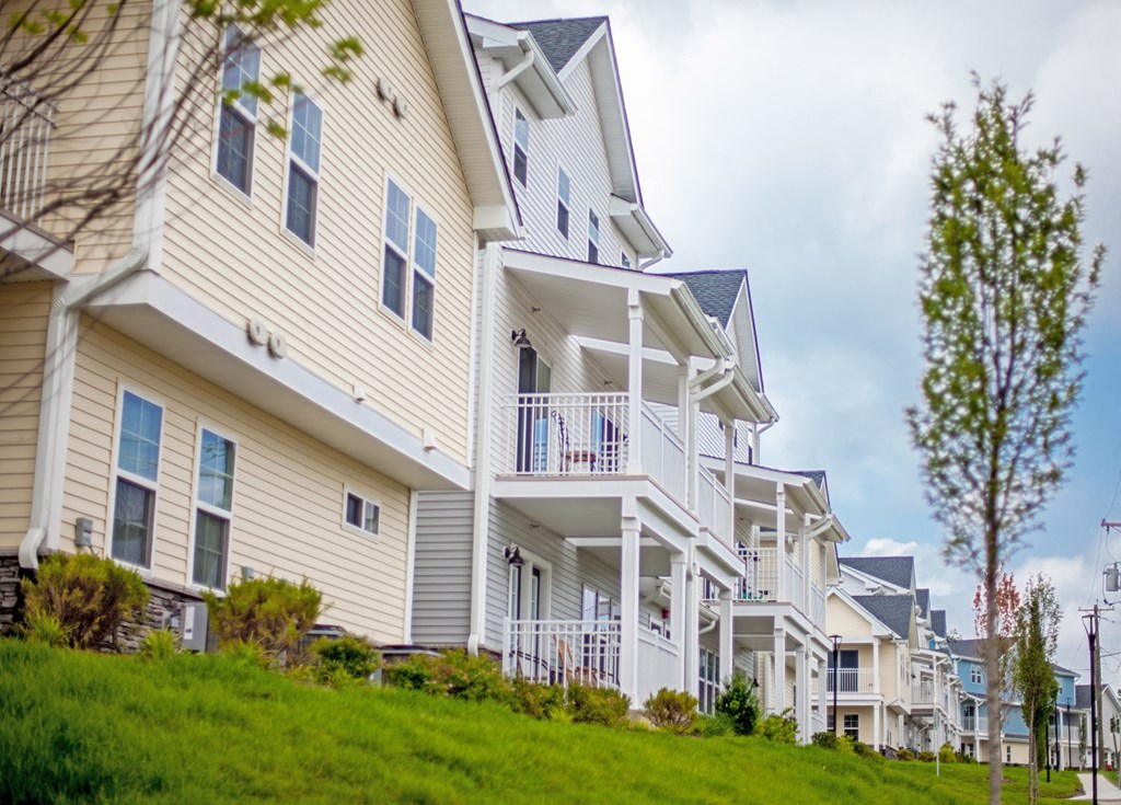a row of houses with balconies on a hill