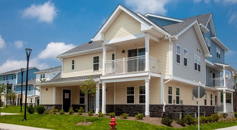 a white house with a porch and a fire hydrant