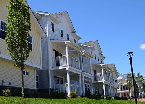a row of houses with balconies on a sunny day