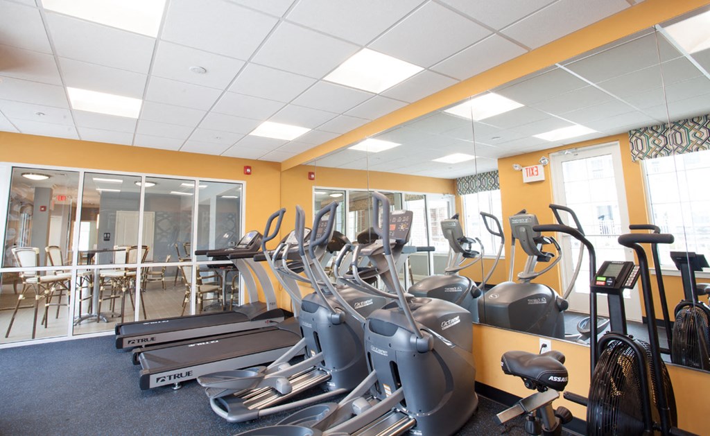 a gym with cardio machines and other exercise equipment