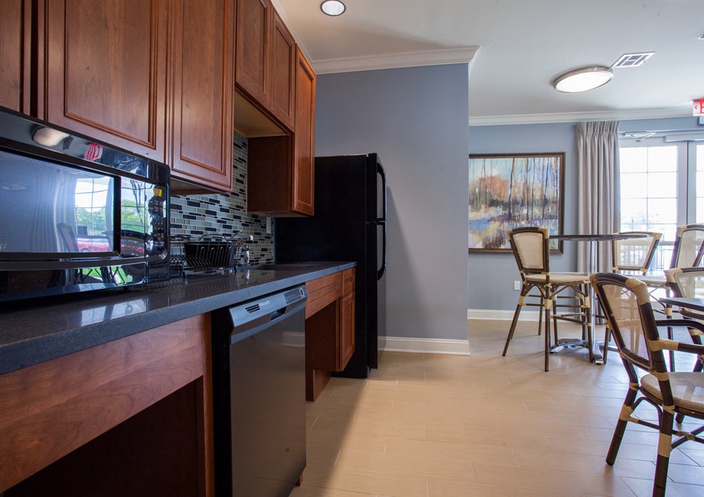 a kitchen and dining room with a table and chairs and a refrigerator