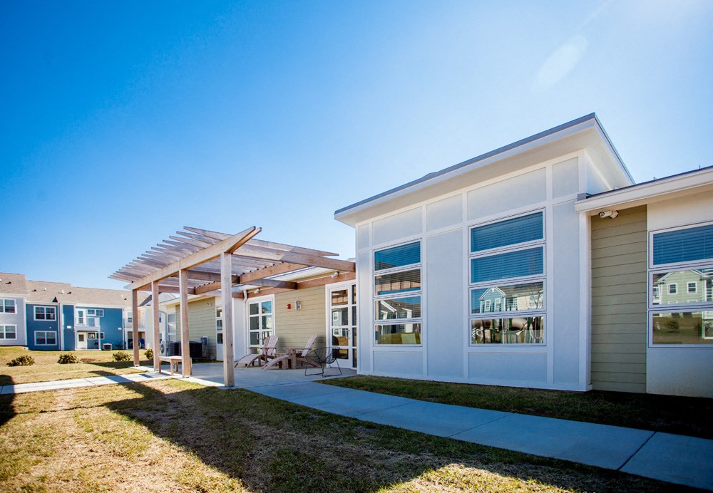 the exterior of a home with a patio and grass