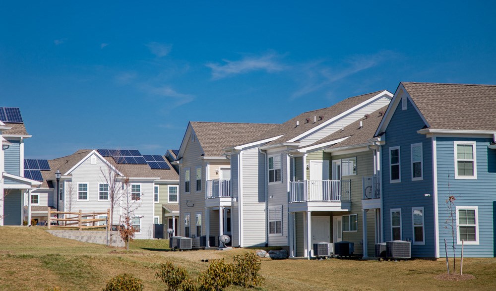 a row of houses with solar panels on their roofs