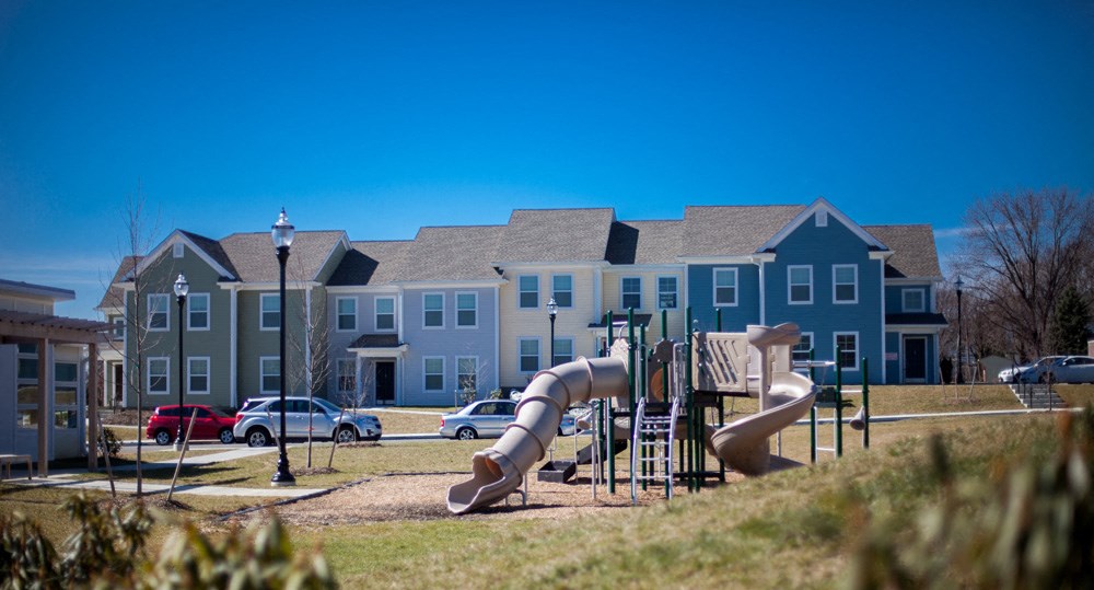 a playground in front of a building with a slide