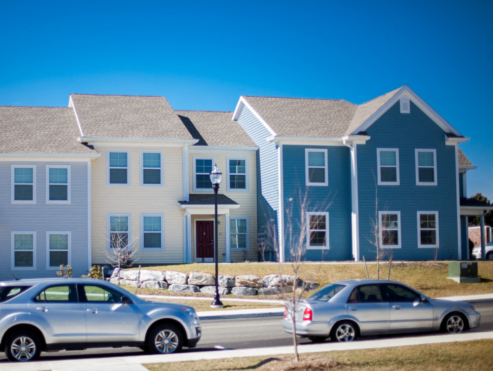 a row of houses on the side of a street