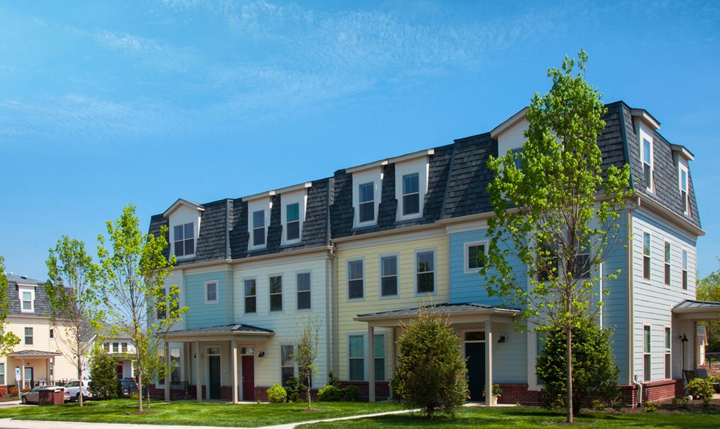 a row of houses with solar panels on the roof