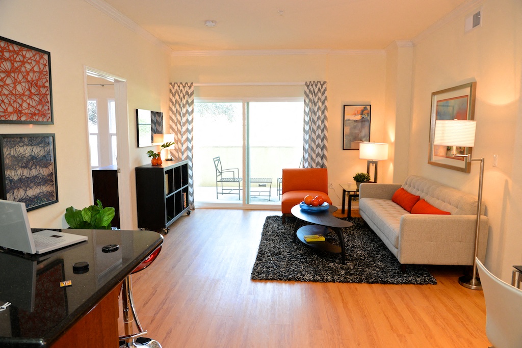 a living room with a couch and a chair and a tv