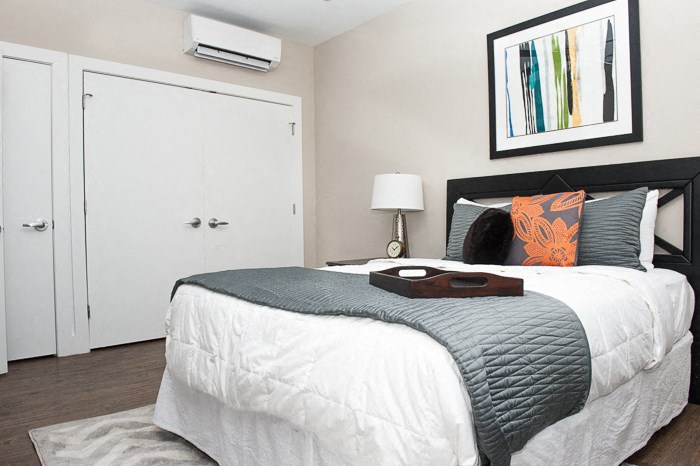 a bedroom with a bed and a white closet