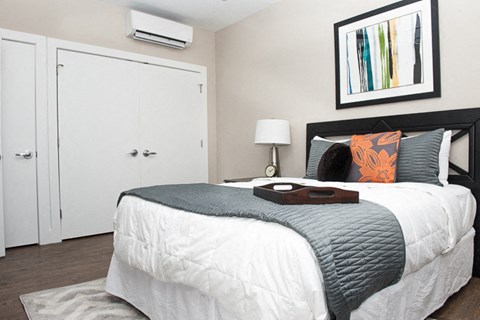 a bedroom with a bed and a white closet