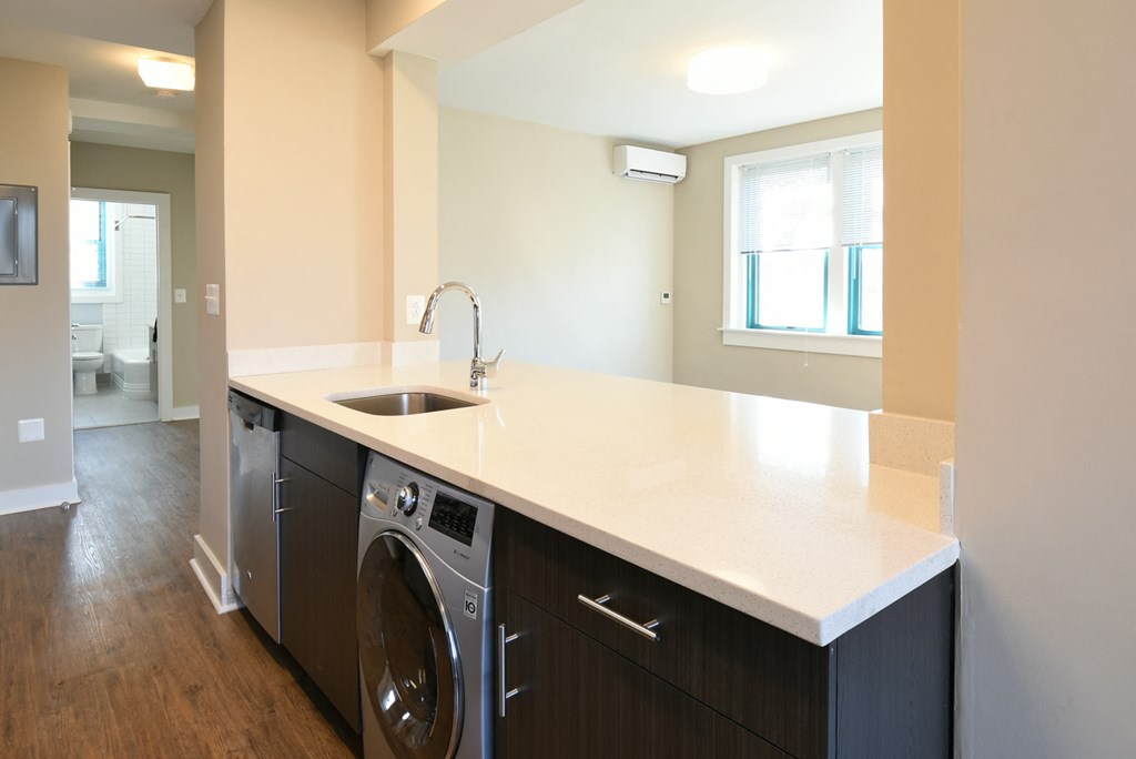a view of a kitchen with a sink and a washing machine