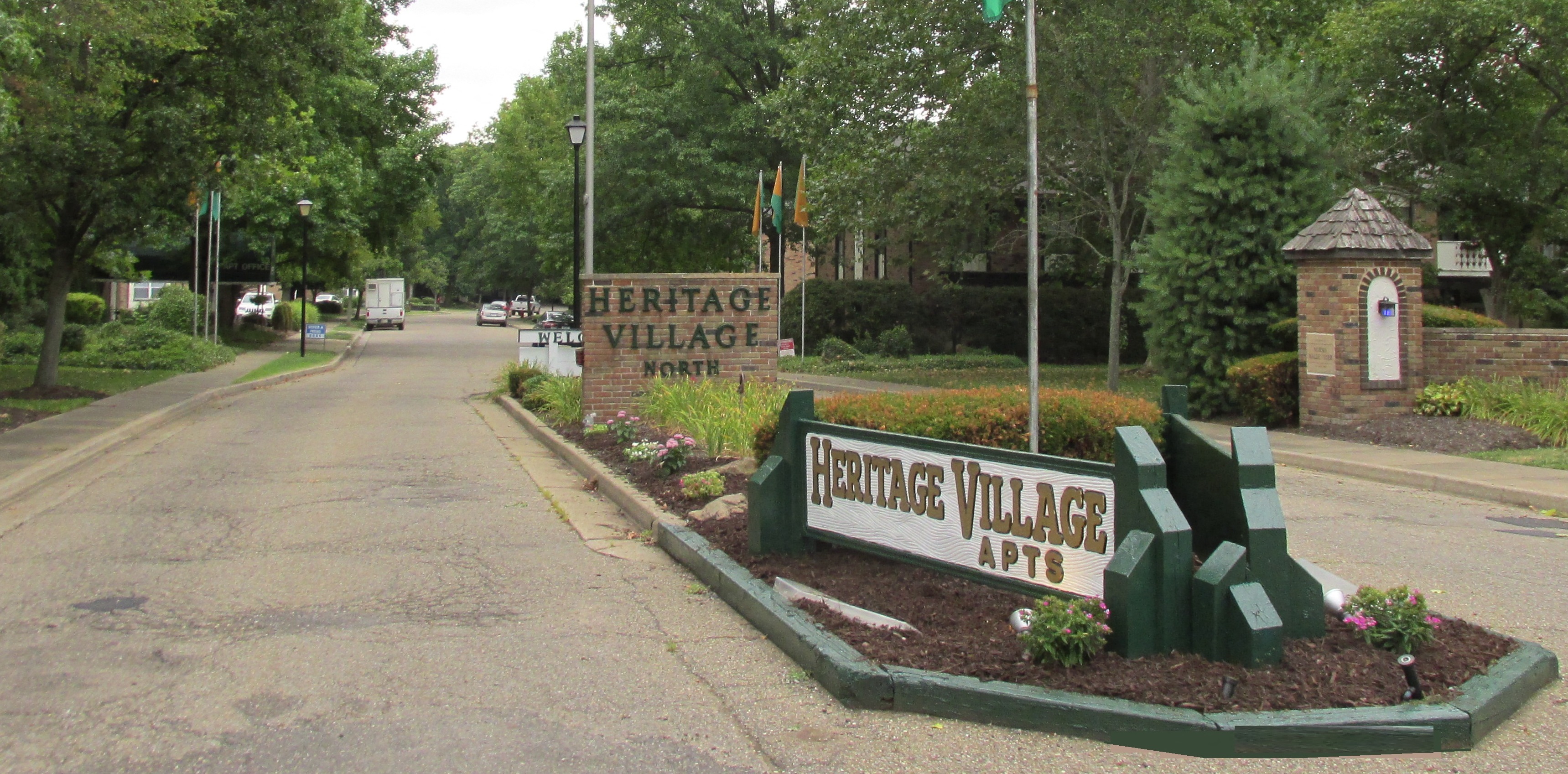 a sign for the entrance to experience village on the side of a road