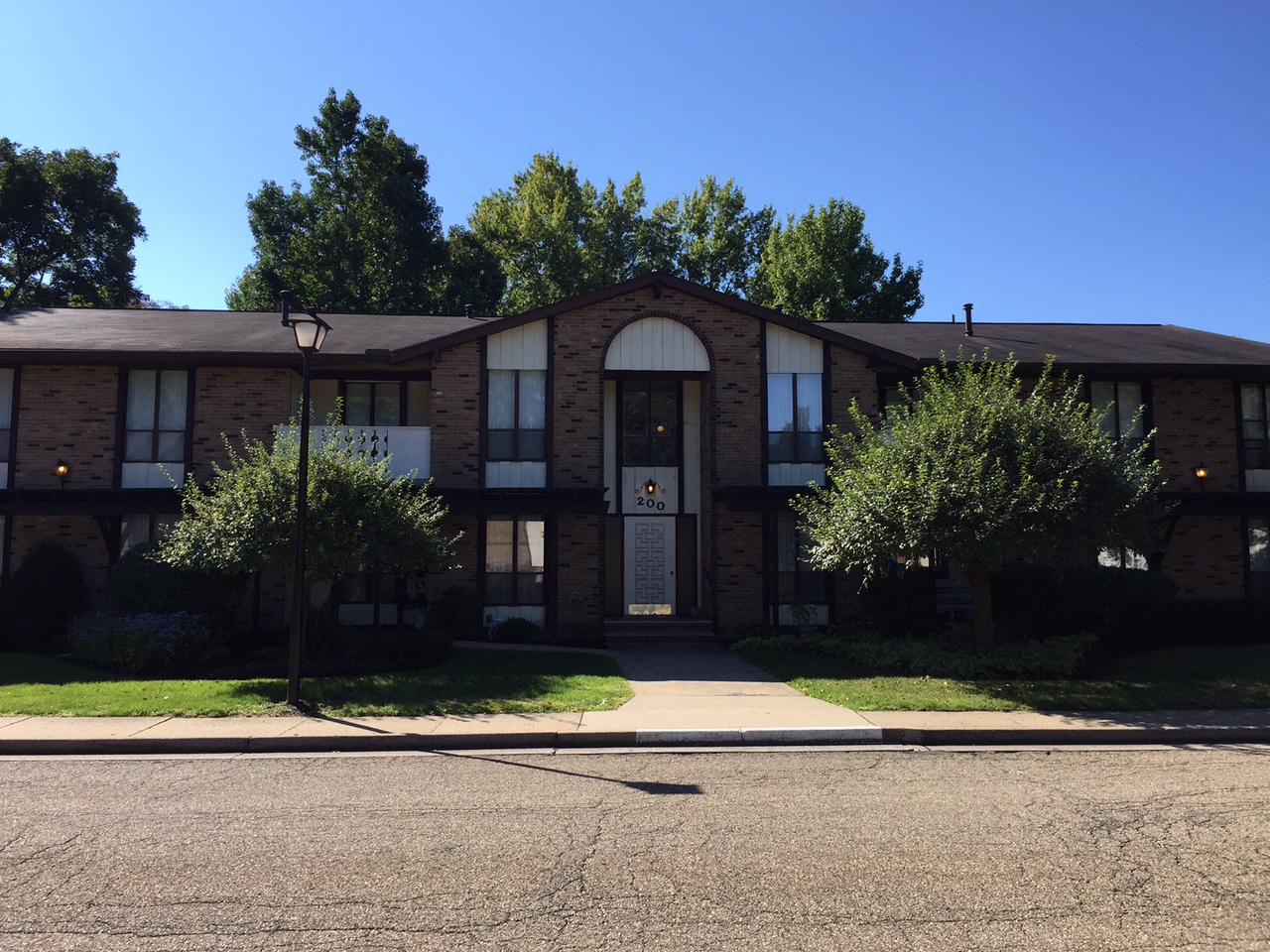 a brick building with a sidewalk in front of it