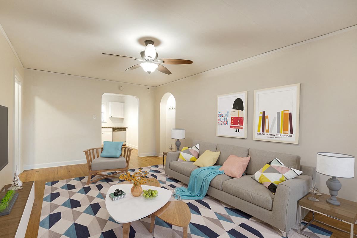 a living room with a couch and a ceiling fan
