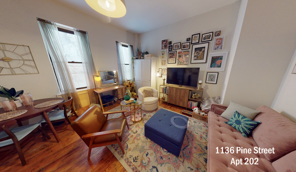 an aerial view of a living room and dining room with furniture and a tv
