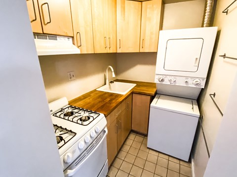 a kitchen with a stove and a sink and a refrigerator