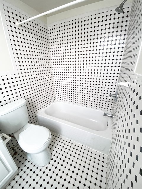 a small bathroom with a toilet and a bath tub