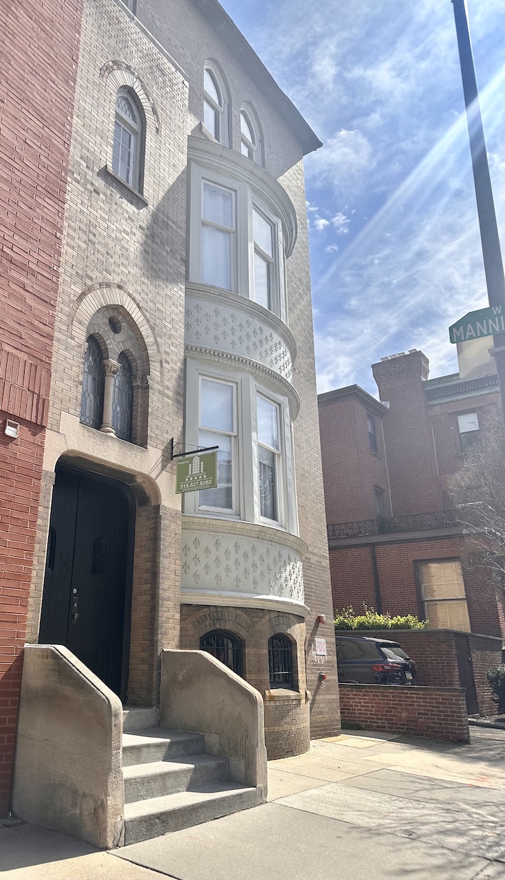a tall building with a street sign in front of it