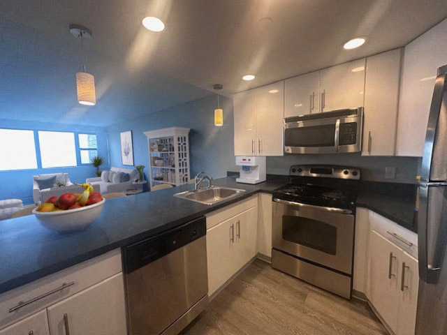 a kitchen with stainless steel appliances and a bowl of fruit