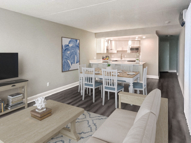 a living room with a dining room table and a kitchen