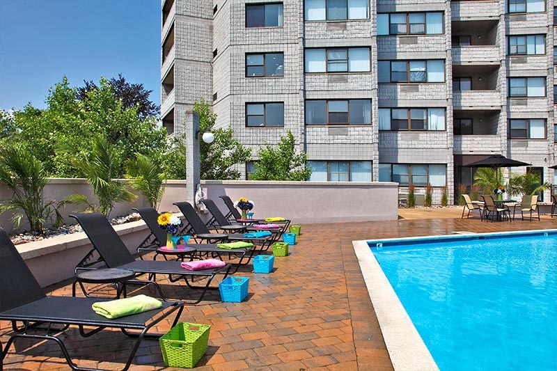 Relax by tanning at the poolside.