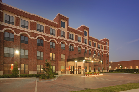 the building in which the hotel is located is lit up at night