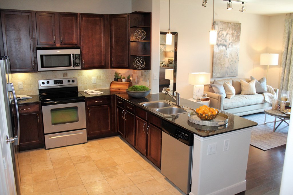a kitchen with stainless steel appliances and wooden cabinets