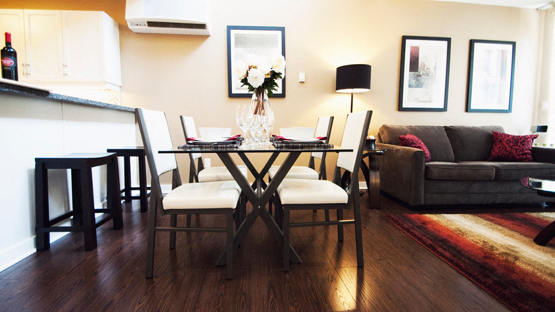 A dining room with a table set for four.