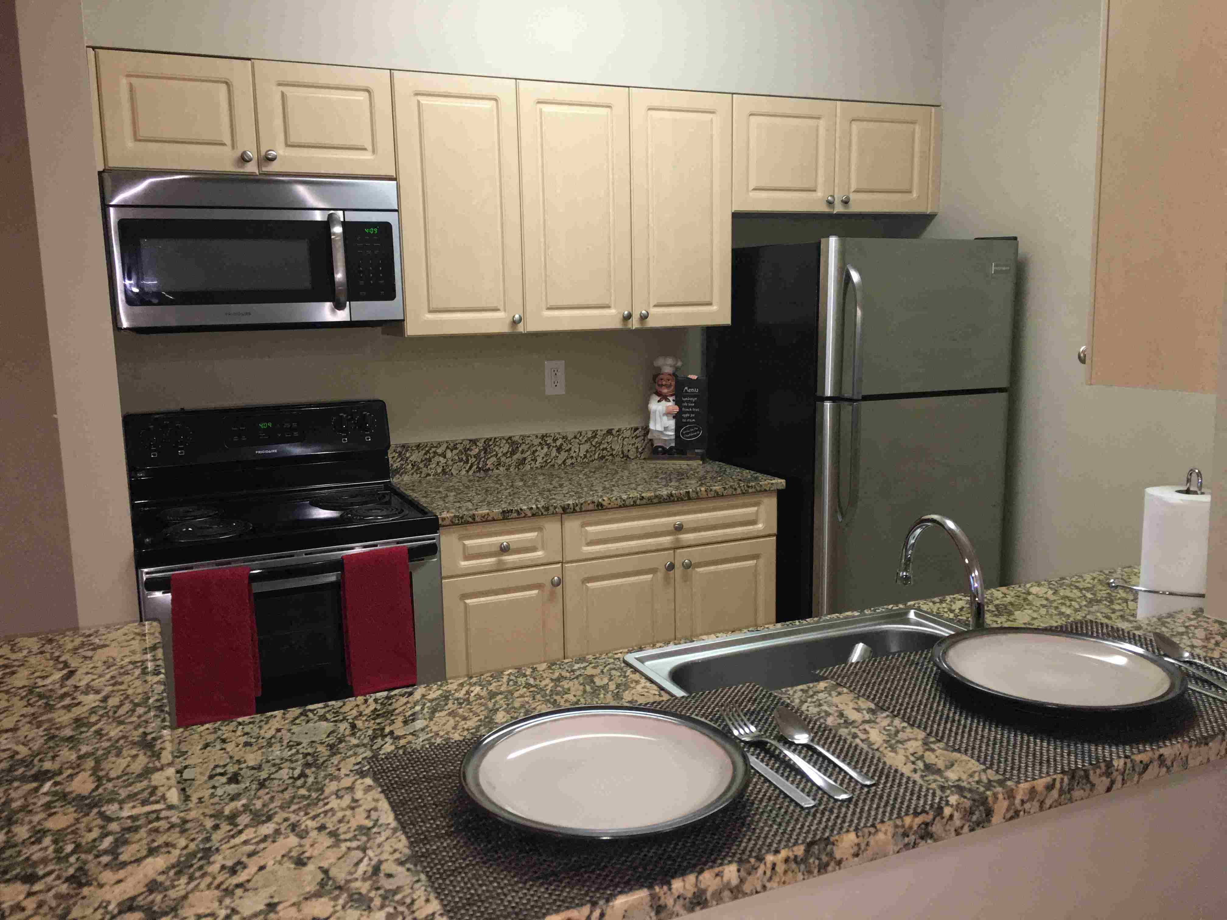 a kitchen with granite counter tops and stainless steel appliances
