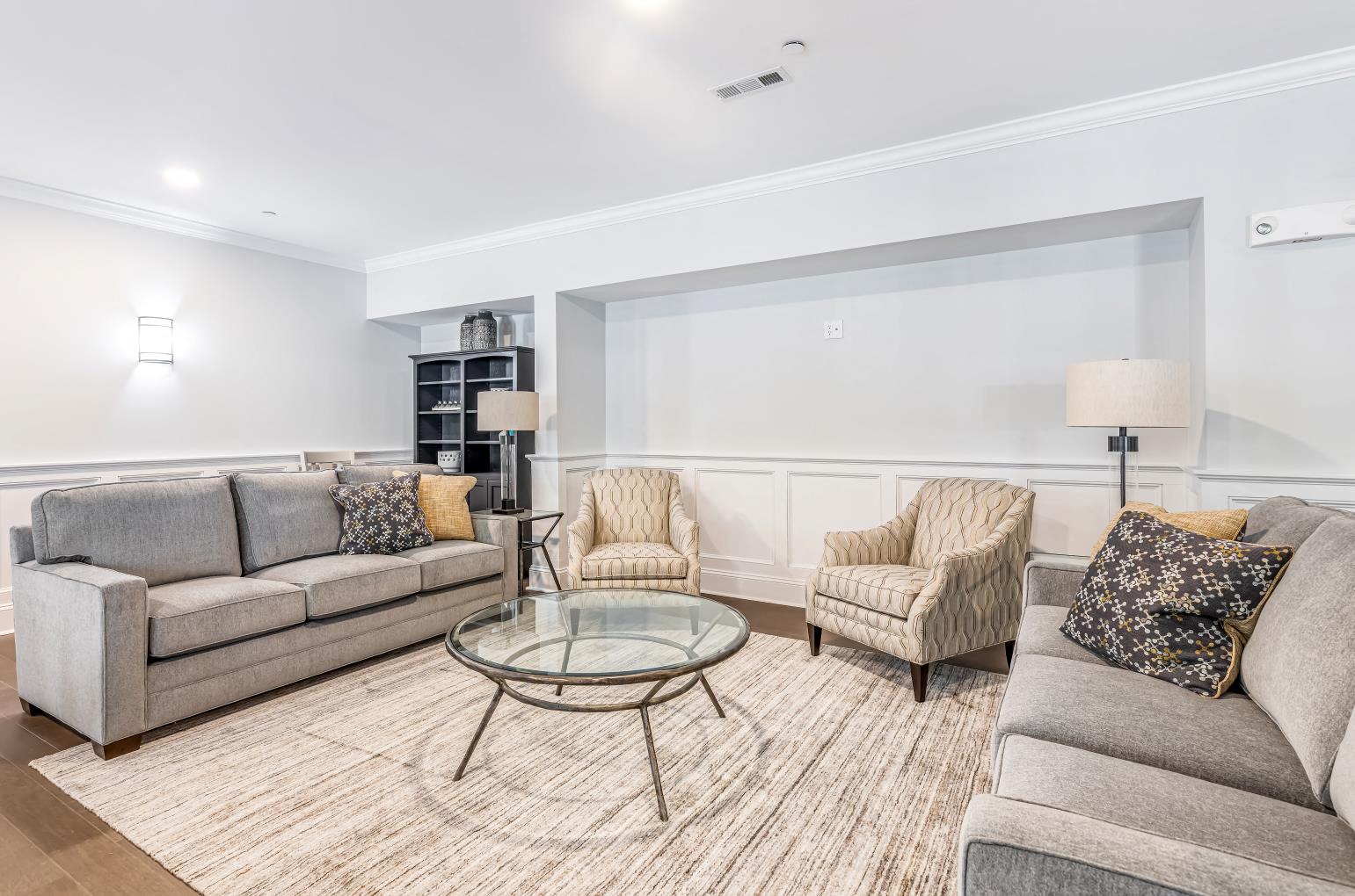 a living room with couches and chairs and a table