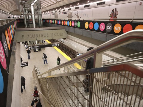 people are walking through a subway station in a busy subway station