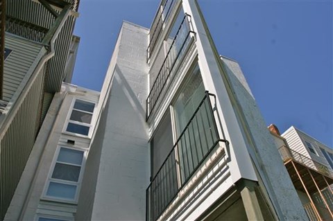 A tall building with a balcony on the side.