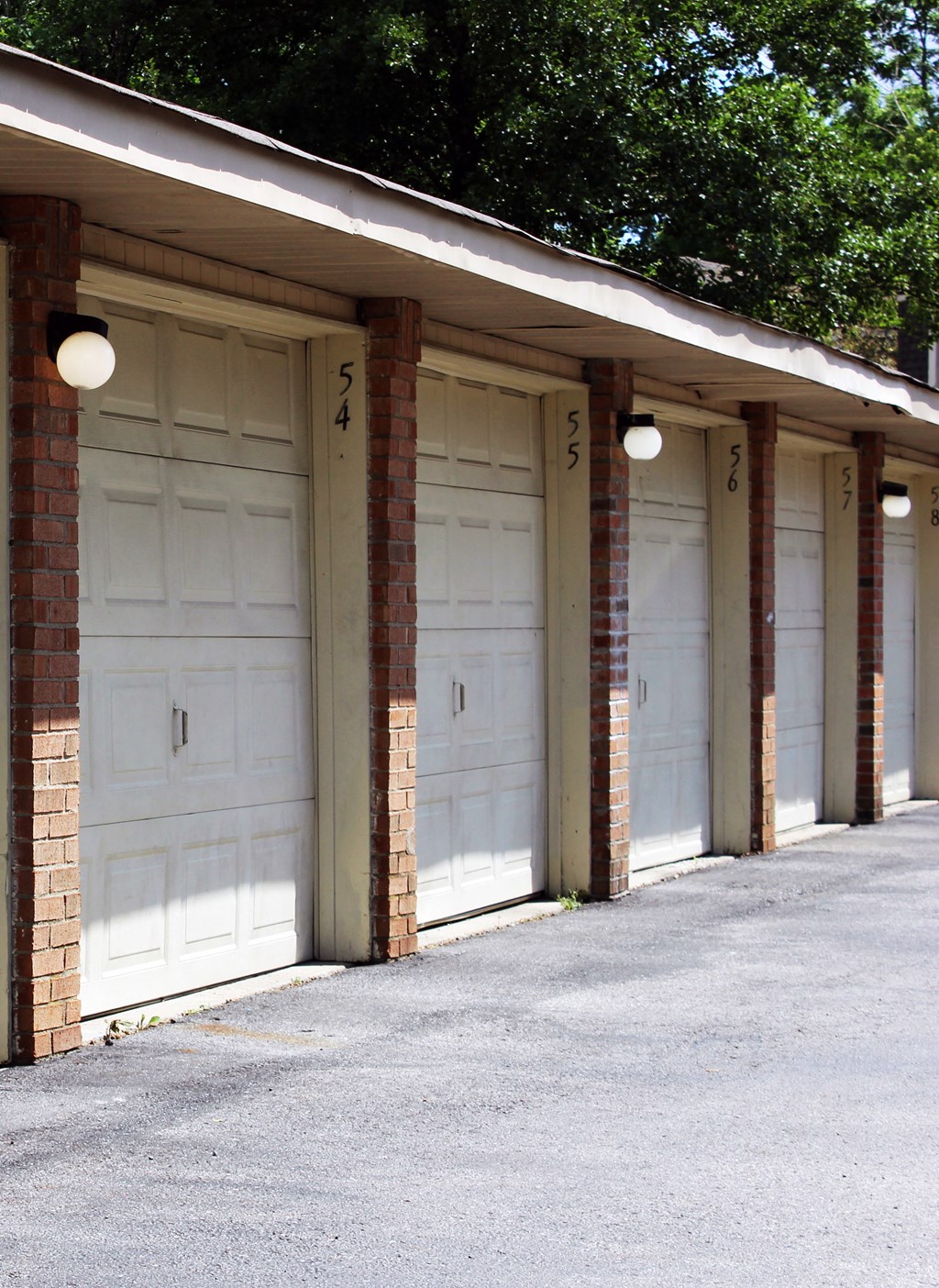 a row of garages with white garage doors