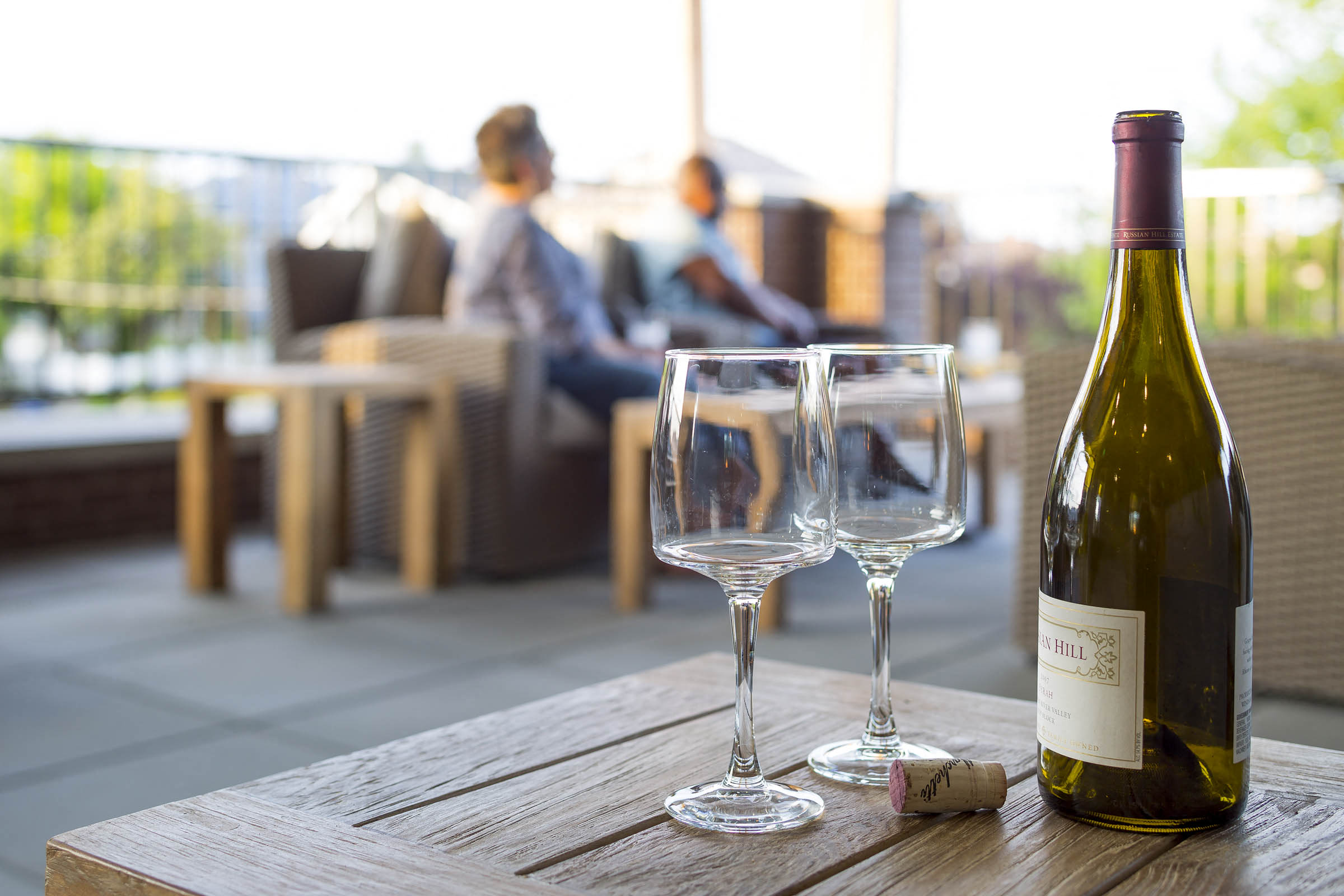 a bottle of wine and two glasses on a table