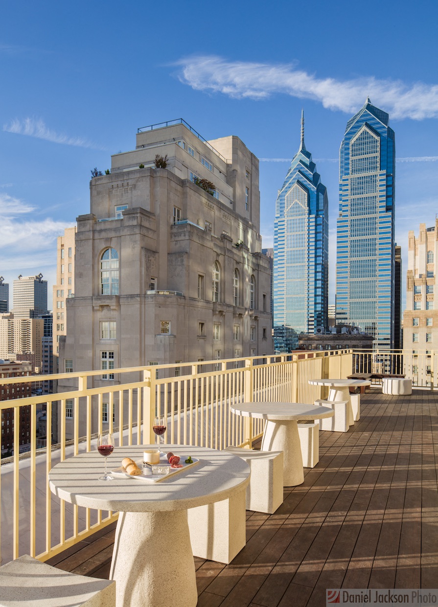 a terrace with tables and chairs on top of a building