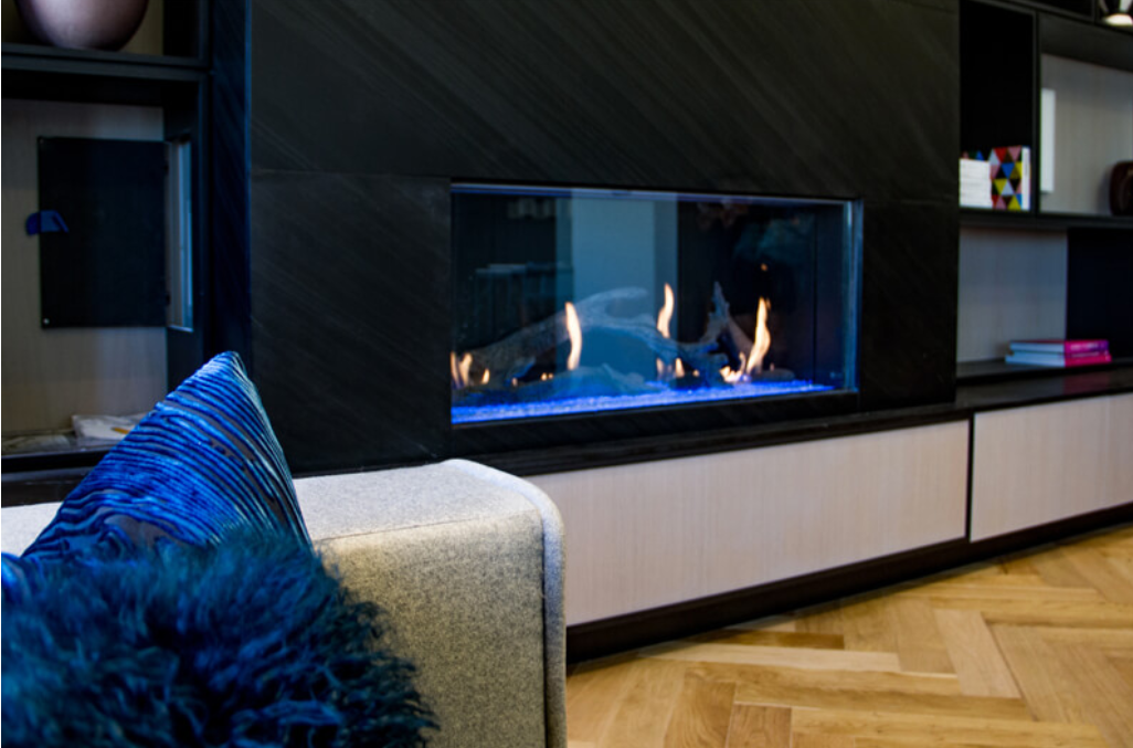 a fireplace with a roaring fire in a living room