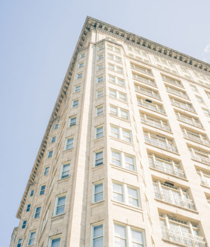a tall building with a blue sky in the background