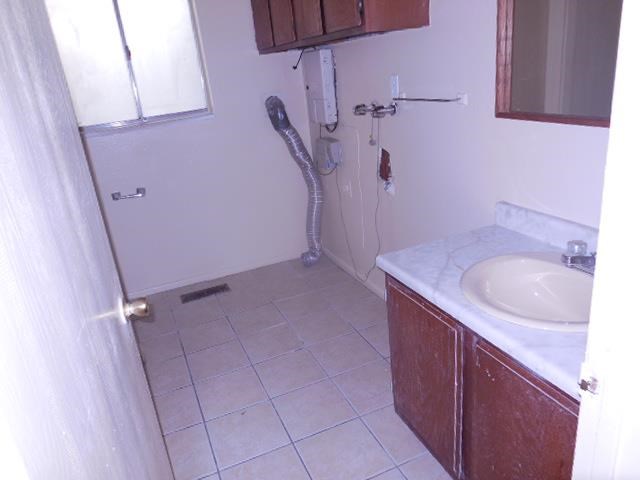 a small bathroom with a sink and a window