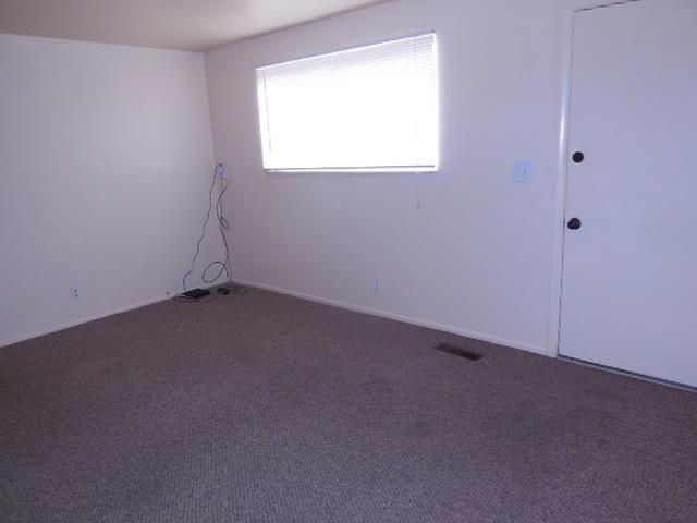 an empty room with a window and a door